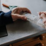 Senior arranges medicines for each day of week